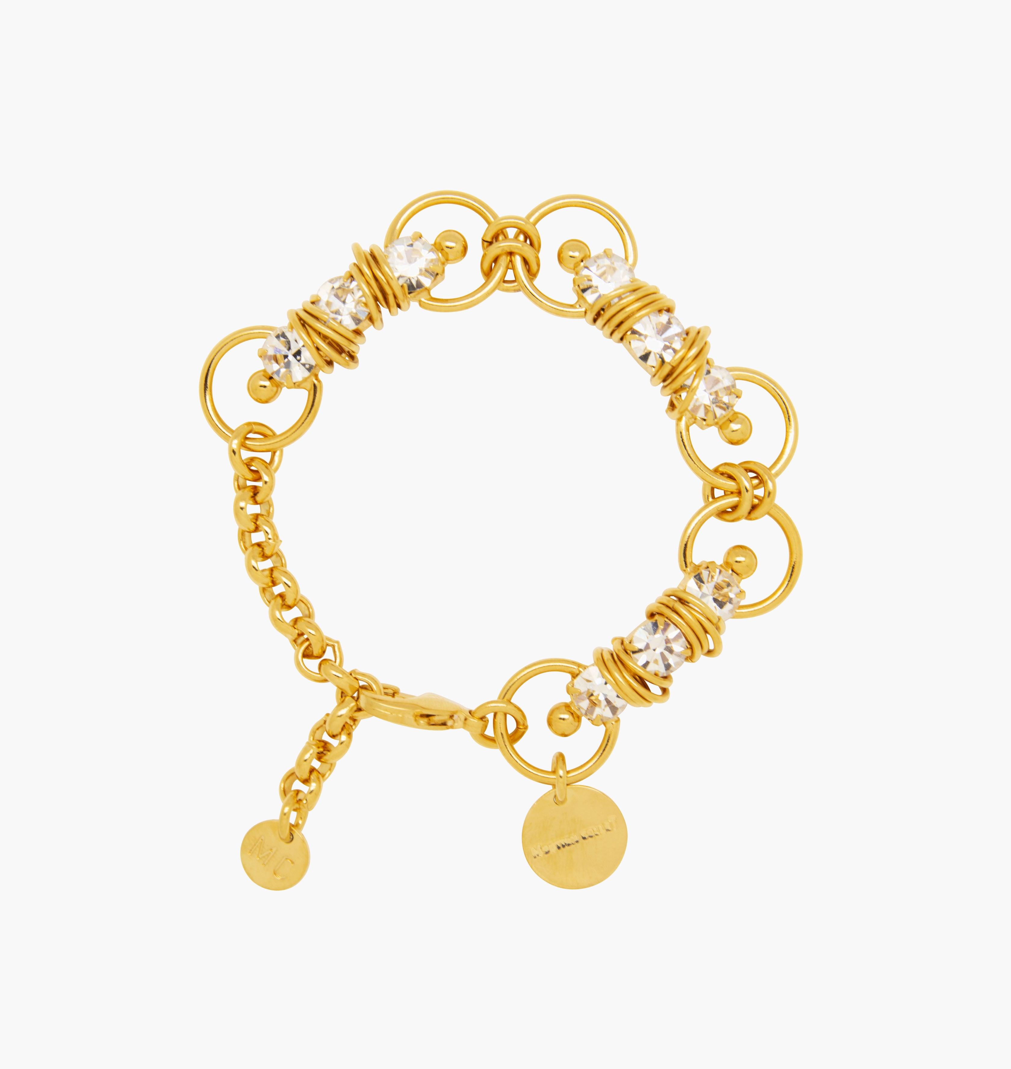 Bracelet MIXY Crystal - shop.mouttoncollet.com, Moutton colleT, Notre bracelet MIXY est réalisé en bronze dorées à l'or fin, serties de cristaux scintillants coloris diamant avec de grands et petits anneaux. Il est orné d'un médaillon gravé "Moutton colleT" et d'un petit logo gravé "MC". Il sera assez discret pour être associé à vos tenues du quotidien. bijoux fantaisie, bijoux de mariage, robe de mariée, bijou de ceremonie, bijoux d'exception, bijoux de luxe,