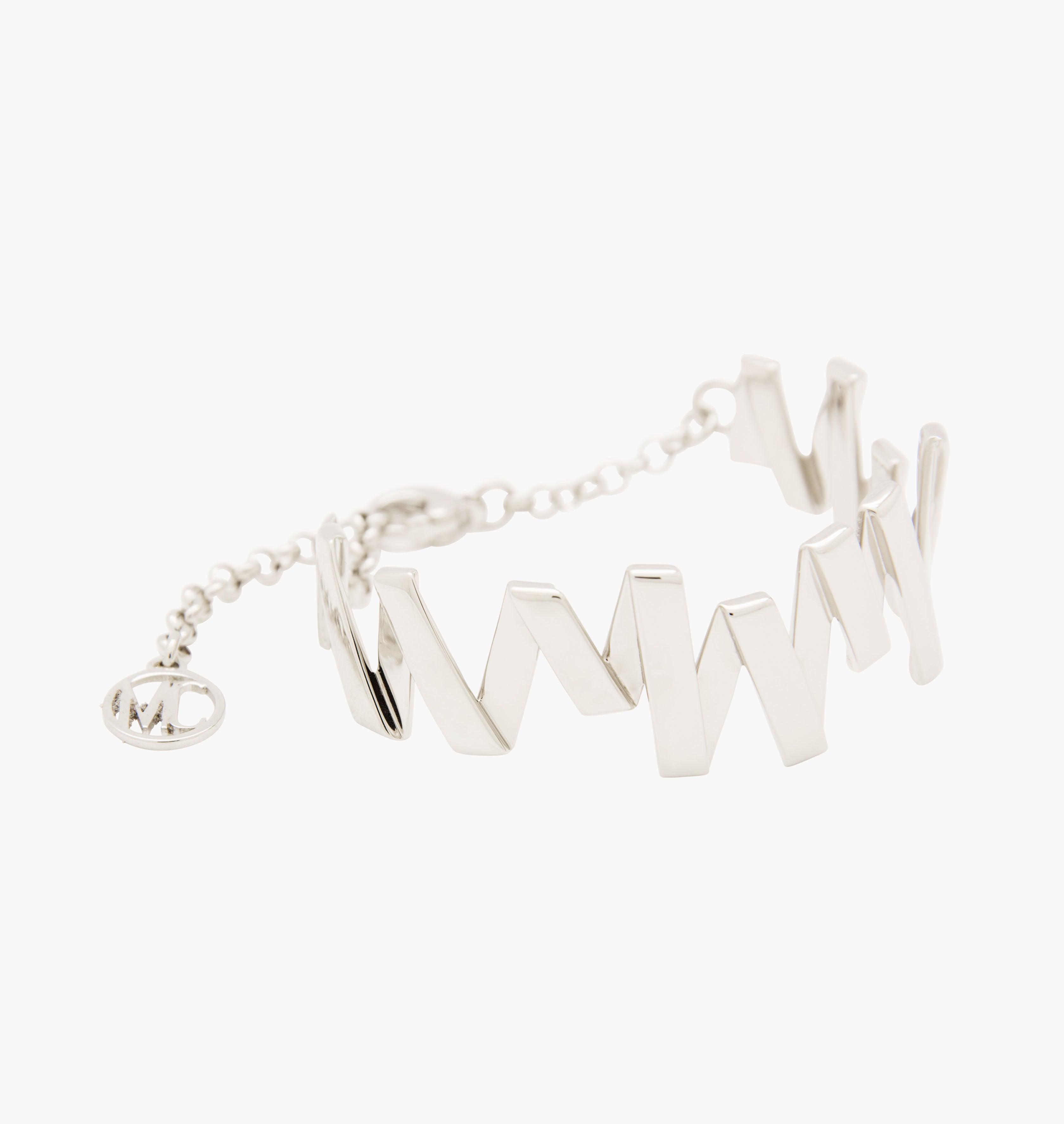 Moutton colleT Notre bracelet VIBRATIONS est réalisé en bronze argenté. Il est orné d'un petit logo "MC". Il habillera votre poignet avec une touche fun et chic, pour un look modern et peps. bijoux argenté argent, bijoux créateurs fabriqué made in Belgium , bracelet originale, bracelet argent argenté, zig zag, éclair, cuff, moderne